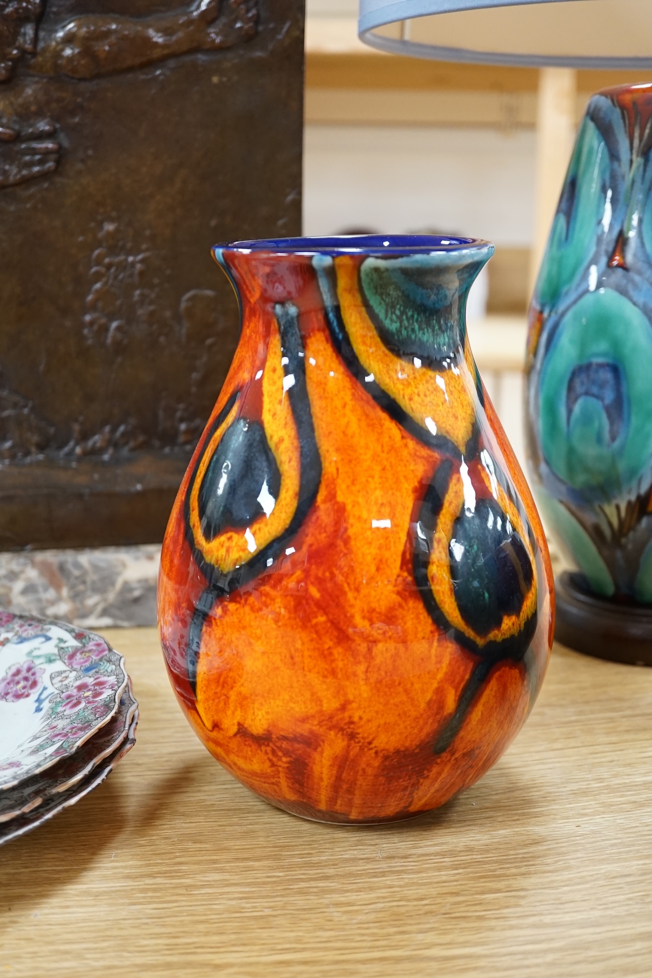 Three pieces of Poole pottery comprising Infusion concave bowl, a peacock design vase and a table lamp with shade, largest 51cm high. Condition - good